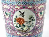 a colorful vase with a bird and flowers on it