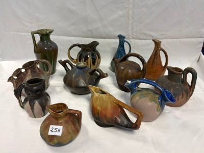 a lot of vases that are sitting on a table