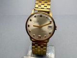 an image of a gold wrist watch on a clear stand