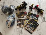a bunch of legos sitting on a table next to a ball of yarn