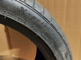 a close up of a tire on a cardboard box with a cardboard box in the background