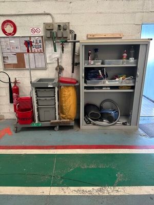a fire extinguisor and a fire hose in a garage