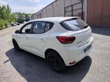 the rear end of a white car parked in a parking lot