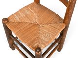 a wooden chair with a woven seat on a white background