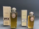 three bottles of perfume sitting next to each other on a table