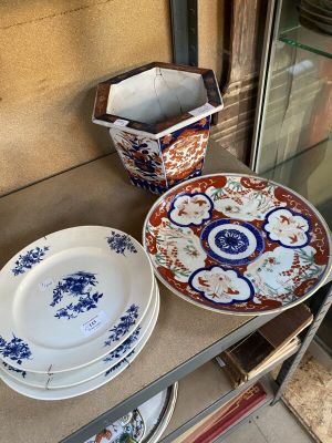 many plates and bowls sitting on a shelf next to a glass door