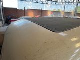 a white car in a garage with a black roof