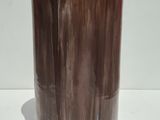 brown and white marble vase with a wooden base on a white surface