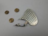 a metal object with a checkered design on it