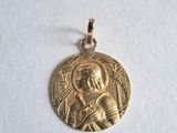 a close up of a gold medal on a white surface