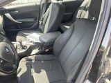 the interior of a car with black seats and a steering wheel