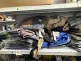 many bags of clothing on a shelf in a store