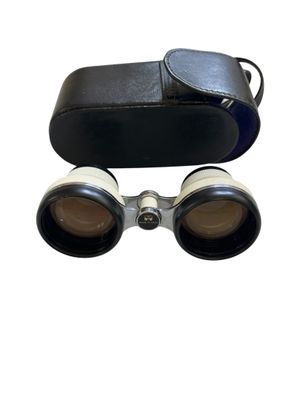 an image of a pair of binoculars sitting on top of a white surface