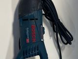 a corded drill with a power cord attached to it