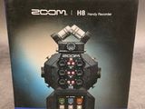 the box for the zoomon h8 camera is open and ready to be used