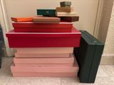 a stack of boxes sitting on the floor next to a suitcase