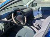 the interior of a blue car with a steering wheel and dashboard