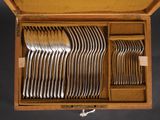 a wooden box with a bunch of silverware in it