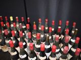 many bottles of wine that are sitting on a table
