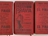 three red books sitting on top of a table next to each other