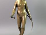 bronze statue of a woman holding a knife and a knife in her hand