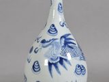 a blue and white vase with a bird design on it