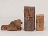 three pieces of leather are sitting on a table next to each other