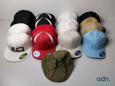 several hats are lined up in a row on a white surface