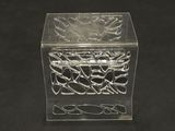 a clear box with a design on it on a black surface