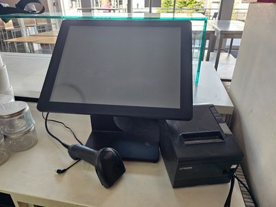 a computer and a printer on a table in a restaurant
