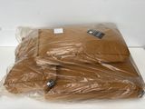 a pile of brown shirts wrapped in plastic on a table