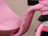 a pink tricycle with a pink seat and handlebars