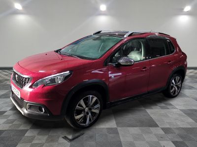 a red car is parked in a room with a checkered floor