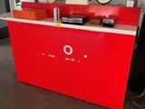 a red counter with a clock on it in a room