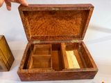 a small wooden box with a note inside of it