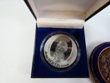 a silver coin with a picture of a man on it