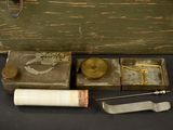 a wooden box with various items in it on a table