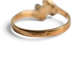 an image of a close up of a gold ring on a white surface