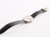 an image of a watch on a white surface with a white background