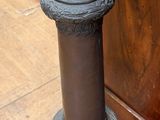 a tall metal pole with a rope on top of it
