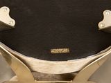 a close up of a gold clock on a stand