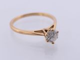a gold ring with a diamond on top of it