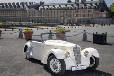 a white car that is parked in front of a building