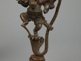 brass statue of a hindu god holding a bow and arrow