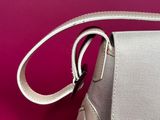 white leather handbag on a pink background