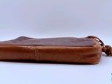 an image of a brown purse sitting on top of a white table