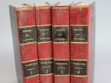 three red books sitting on top of each other on a white surface