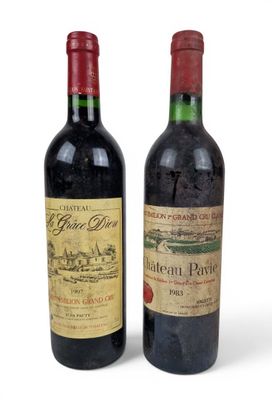 two bottles of wine sitting next to each other on a white surface