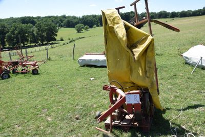 a yellow cloth on the back of a tractor in a field
