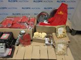 boxes of assorted items sit on a pallet in front of a sign